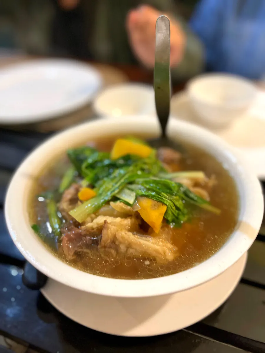 A steaming bowl of nilagang baka with greens and squash